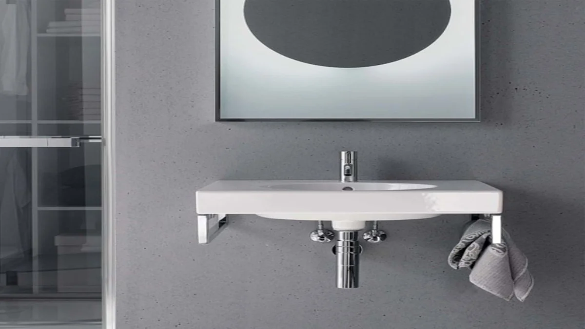 Lavabo Geberit Preciosa II avec porte-serviettes, devant un mur gris.